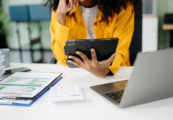 Businesswoman utilizing smartphone and tablet technology. Perfect for corporate, technology, and modern business visuals