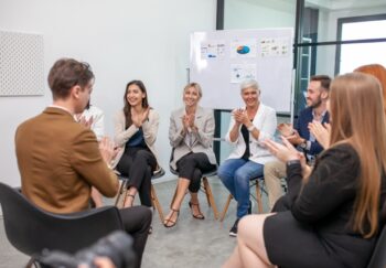 business team male and female colleagues talking at work share ideas with chart on board, Happy young presentation colleagues work together on board.